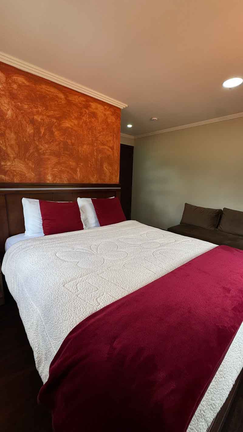 Double bed with red accents